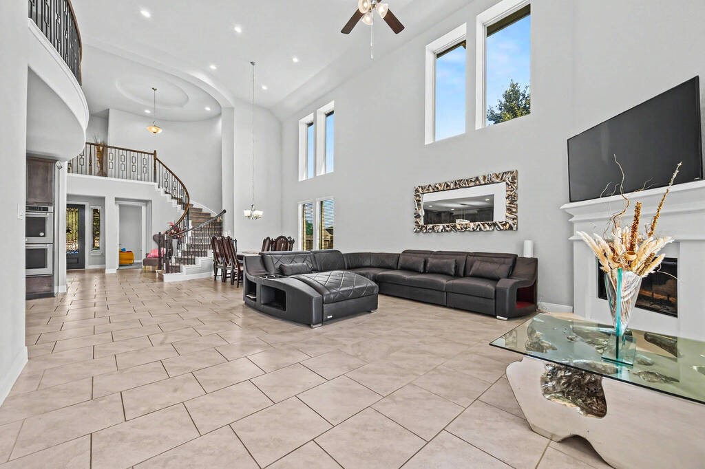 Huge living room/dining room space filled with natural light, open to the kitchen and leading to the back patio.