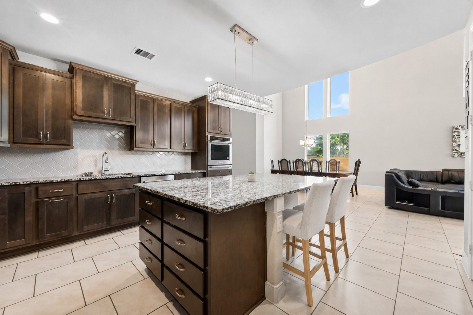 Extra large island can sit 6, open to the living room. The center of this upgraded kitchen does not disappoint.