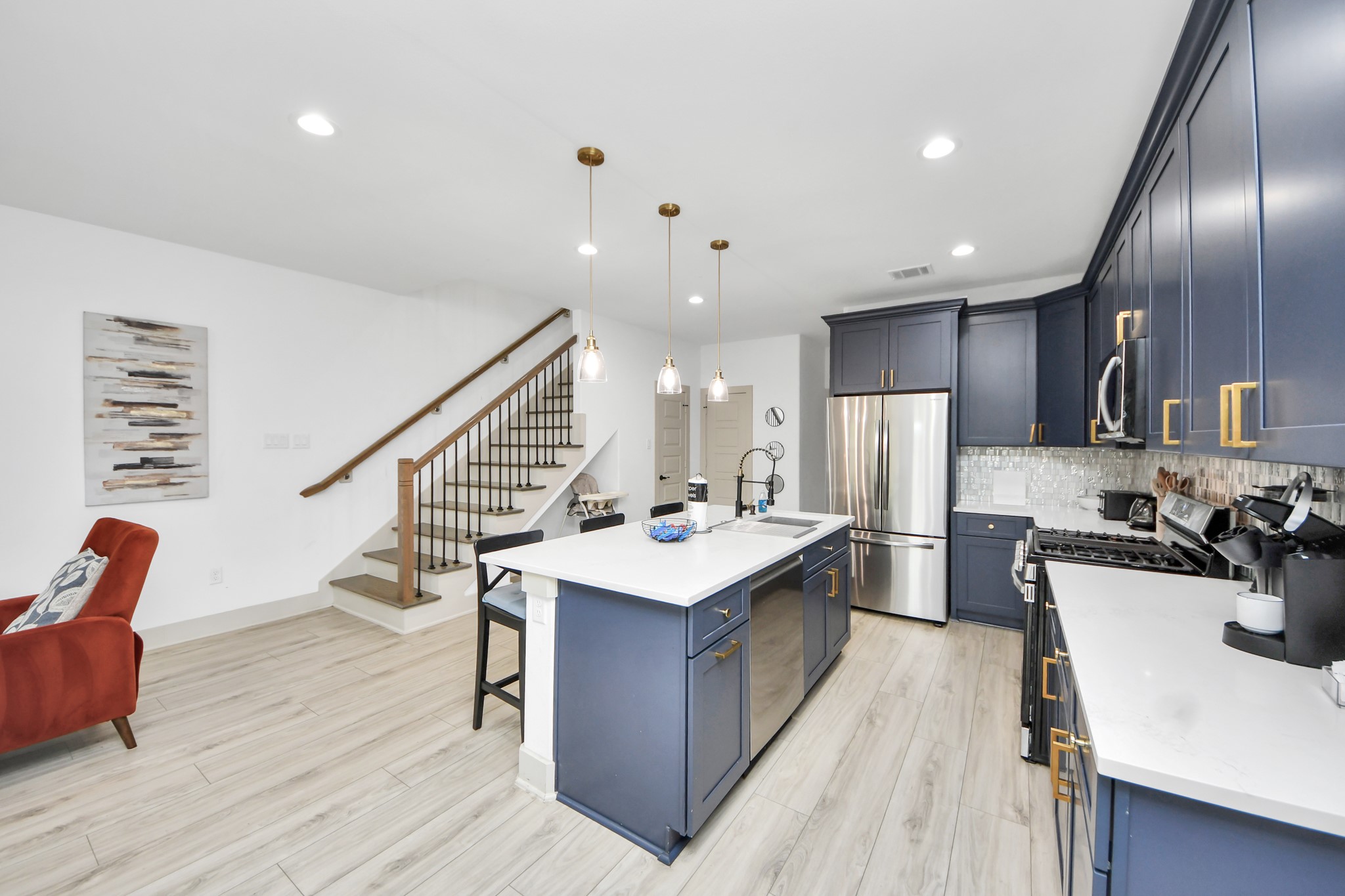 Stylish staircase with wrought-iron detailing adds architectural character to this newer Houston duplex.
