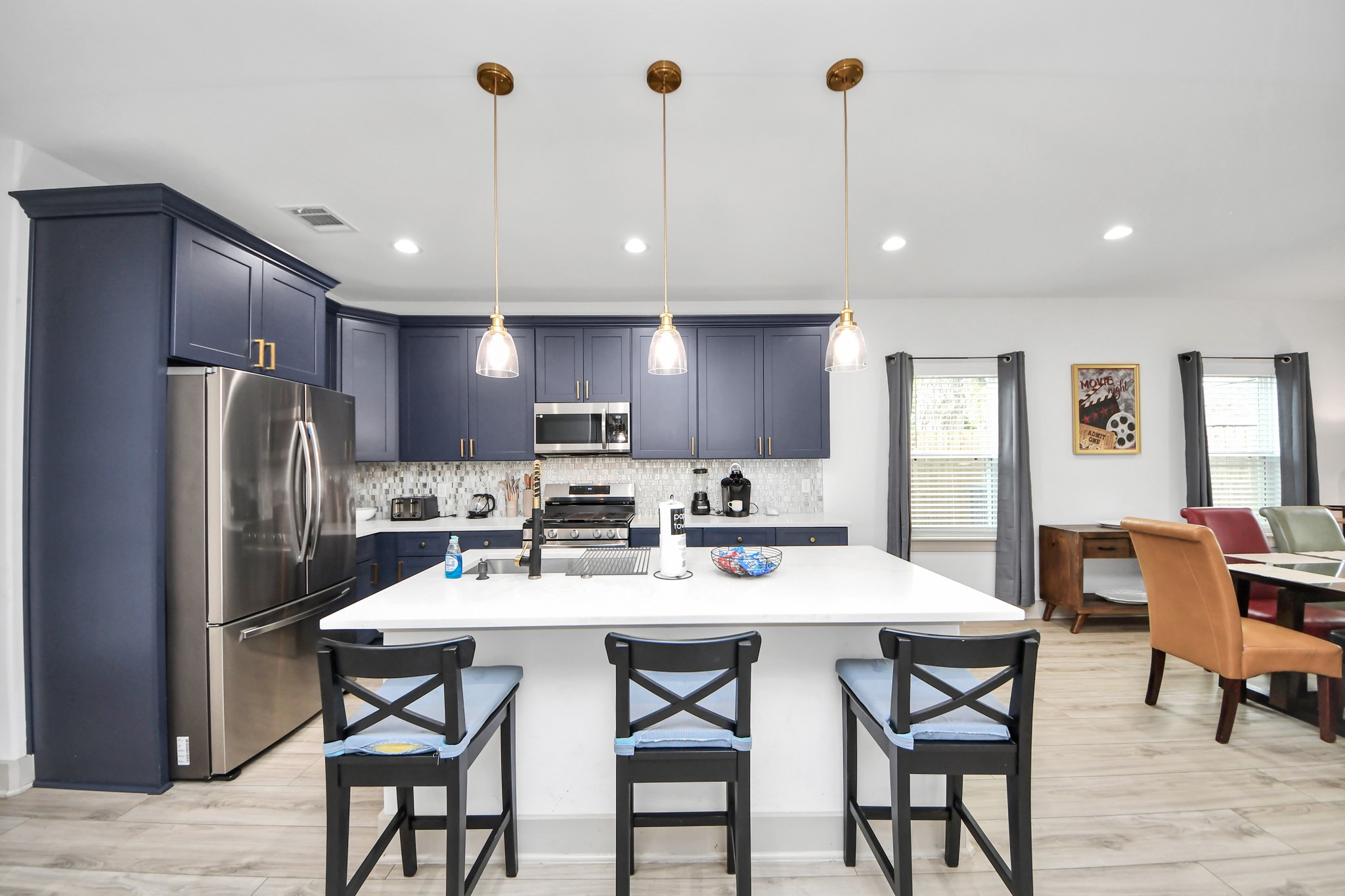 Modern Houston duplex kitchen featuring generous counter space, stylish cabinetry, stainless appliances, and an oversized island.