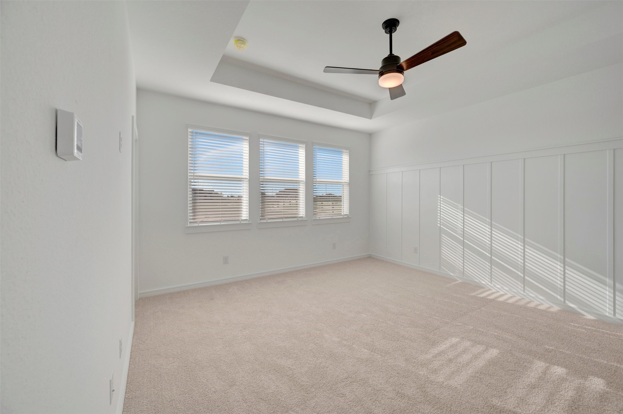 Secluded primary suite with decorative feature wall