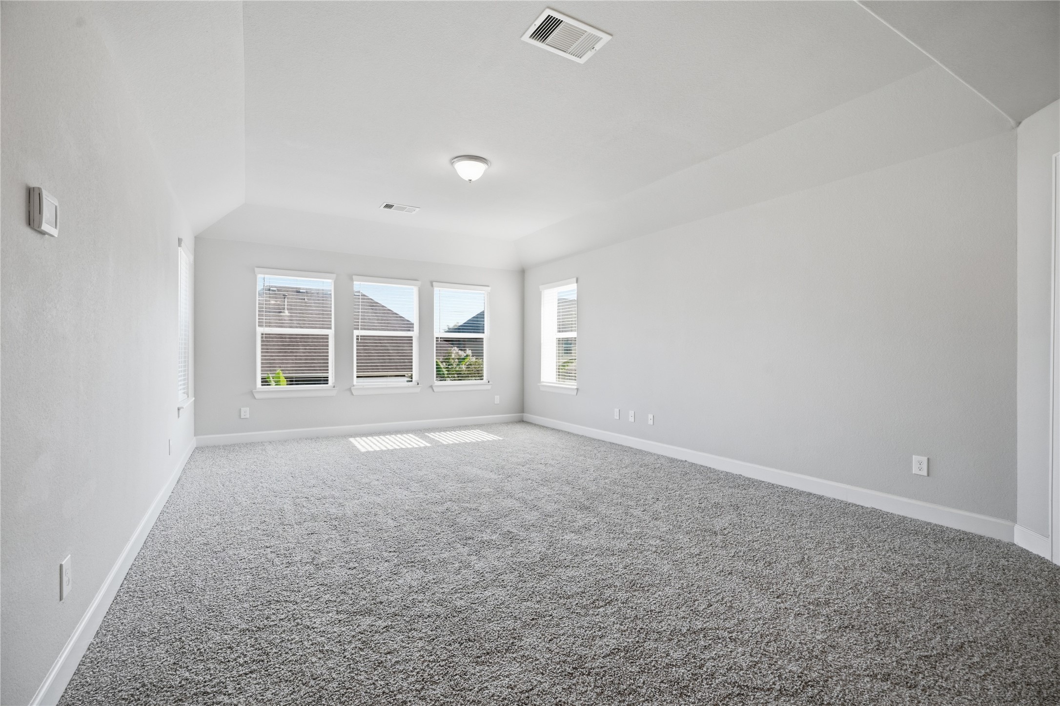Spacious game room sits at the top of the stairs and creates a central gathering space between the upstairs bedrooms.