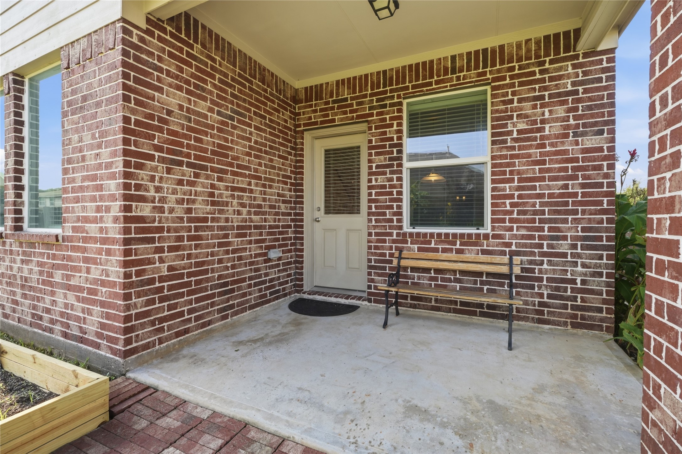 Covered back patio provides a shaded space to enjoy the outdoors, with direct access to the home and views of the backyard.