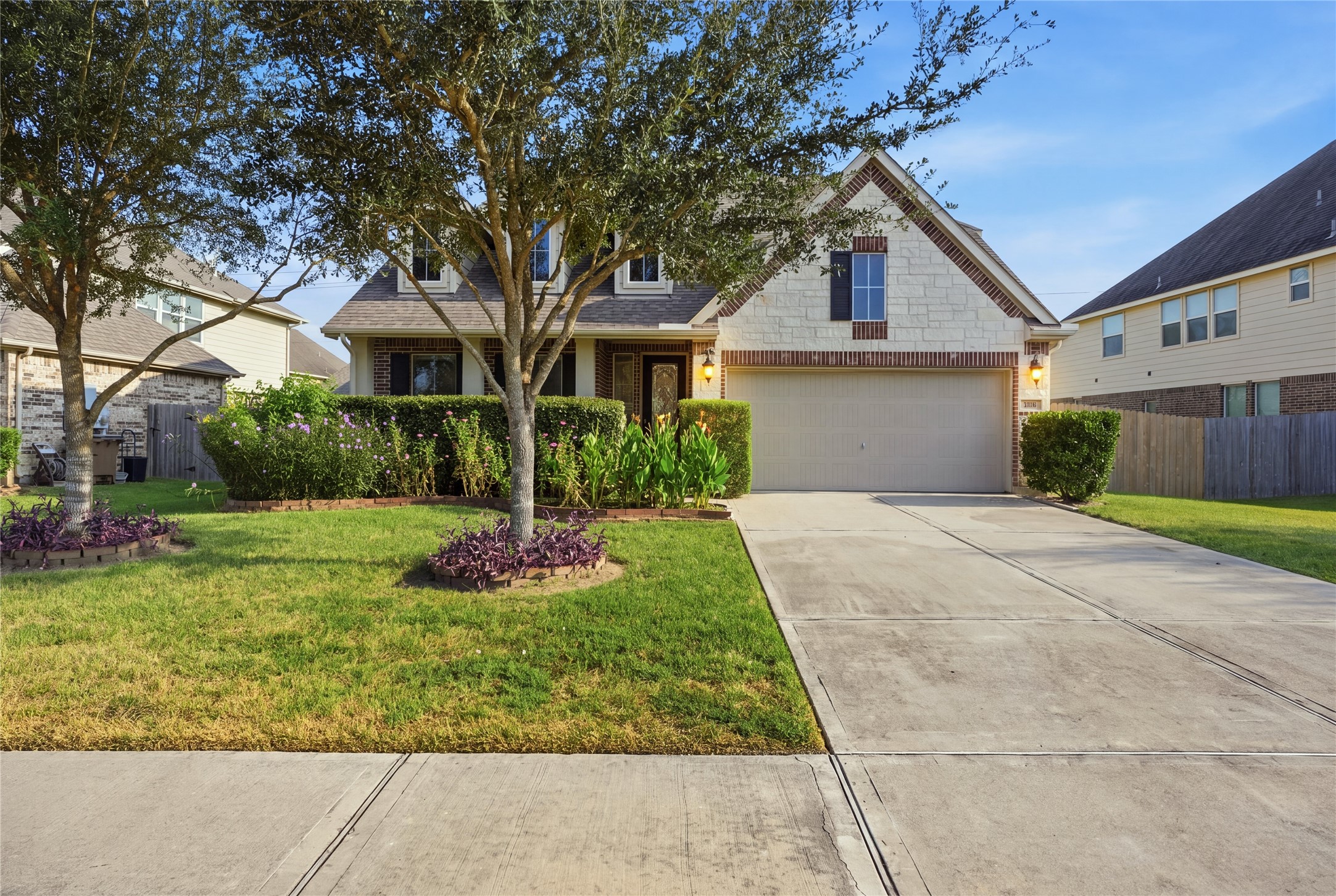 Beautiful curb appeal welcomes you with mature trees, a well-maintained lawn, established landscaping, and an attractive brick and stone exterior. Beautiful curb appeal welcomes you with mature trees, a well-maintained lawn, established landscaping, and an attractive brick and stone exterior.