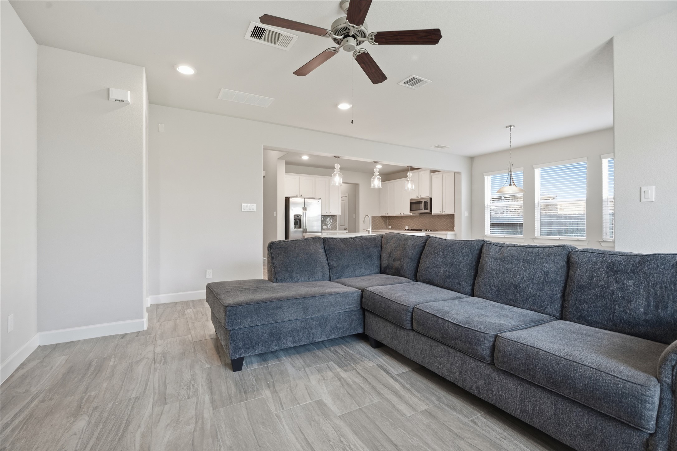 Another view highlights the generous size of the living room and its open connection to the kitchen and breakfast area.