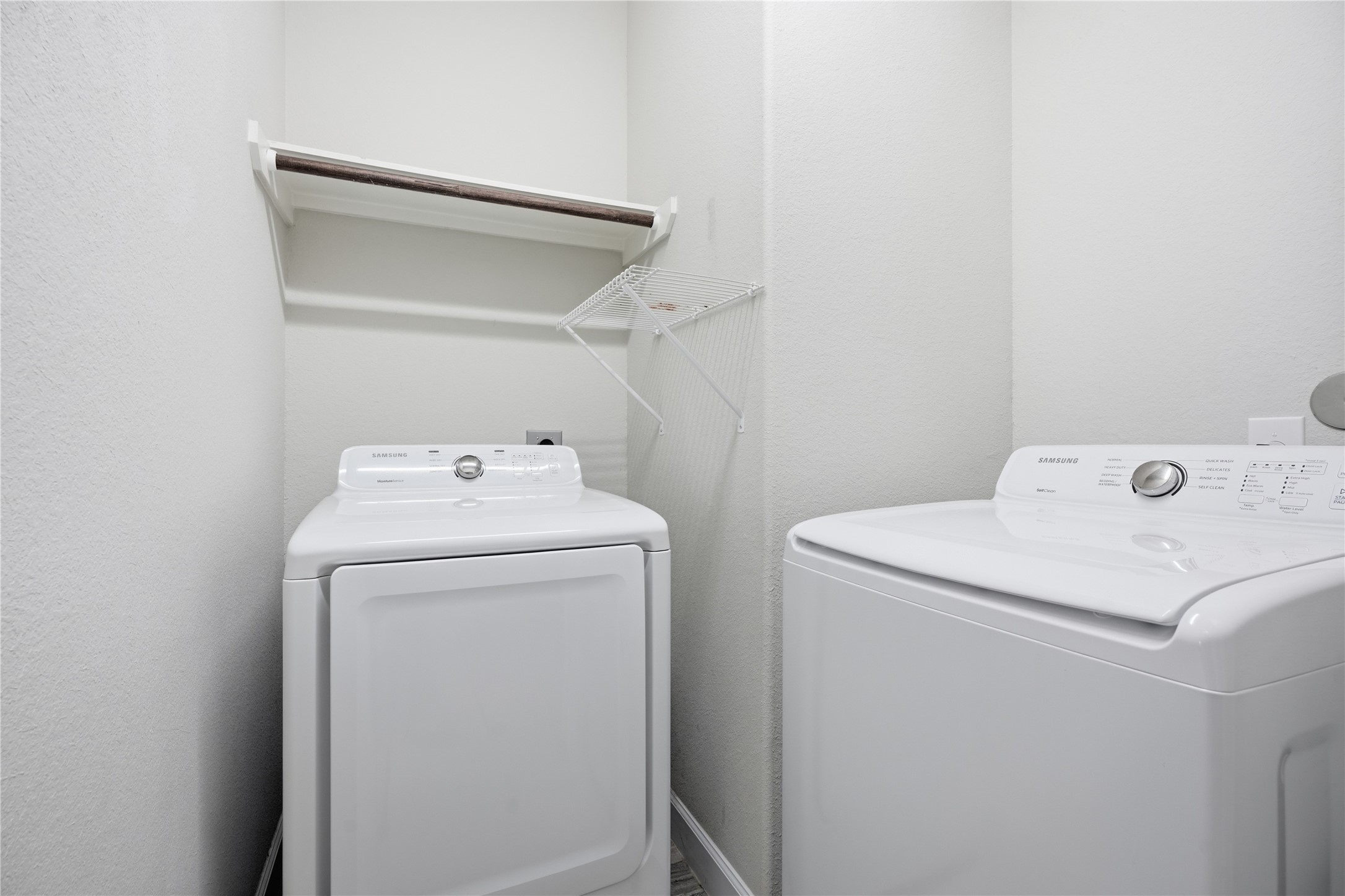 Dedicated laundry room offers built-in cabinetry for convenient storage and organization.