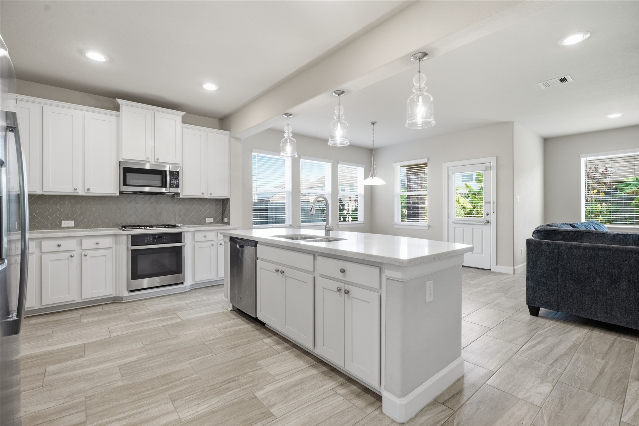 The kitchen offers an open, functional layout with ample storage and counter space, stainless steel appliances, and easy flow into the surrounding living areas.