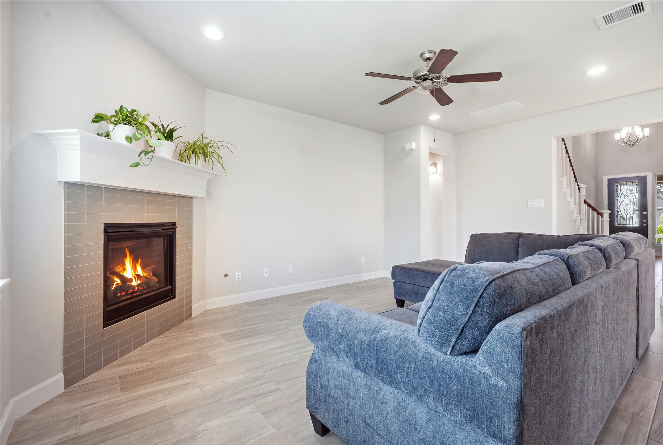Inviting living room features a fireplace with a striking floor-to-ceiling surround, creating an eye-catching focal point in the space.