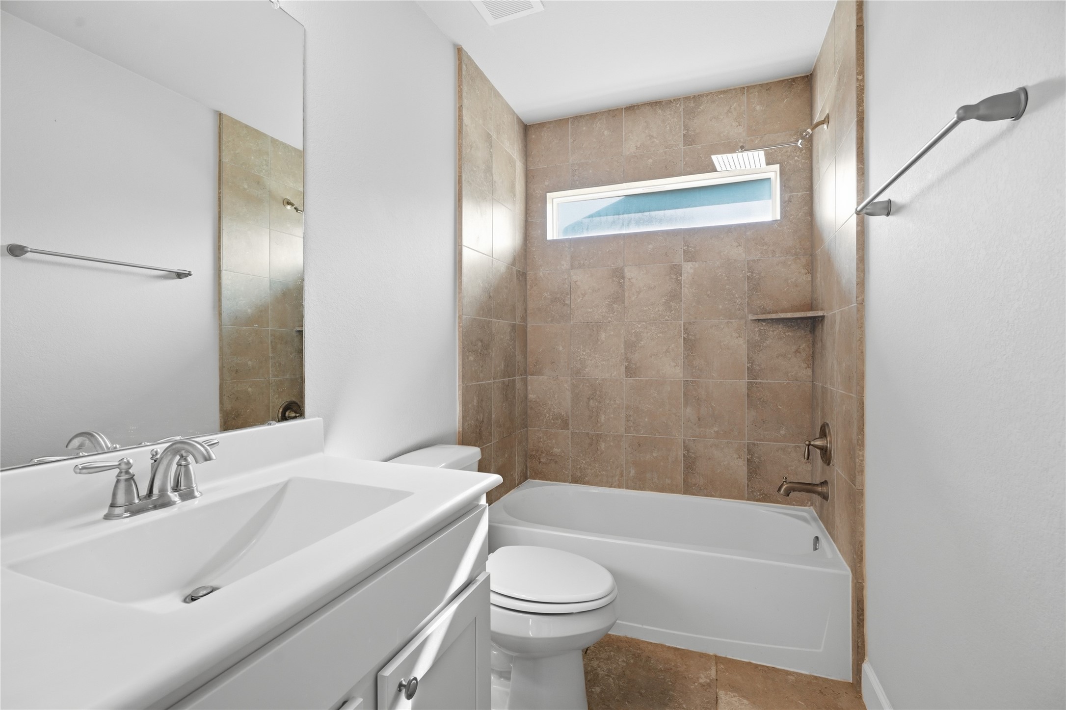 Private full bathroom located within the secondary bedroom provides added privacy and convenience for family or guests.