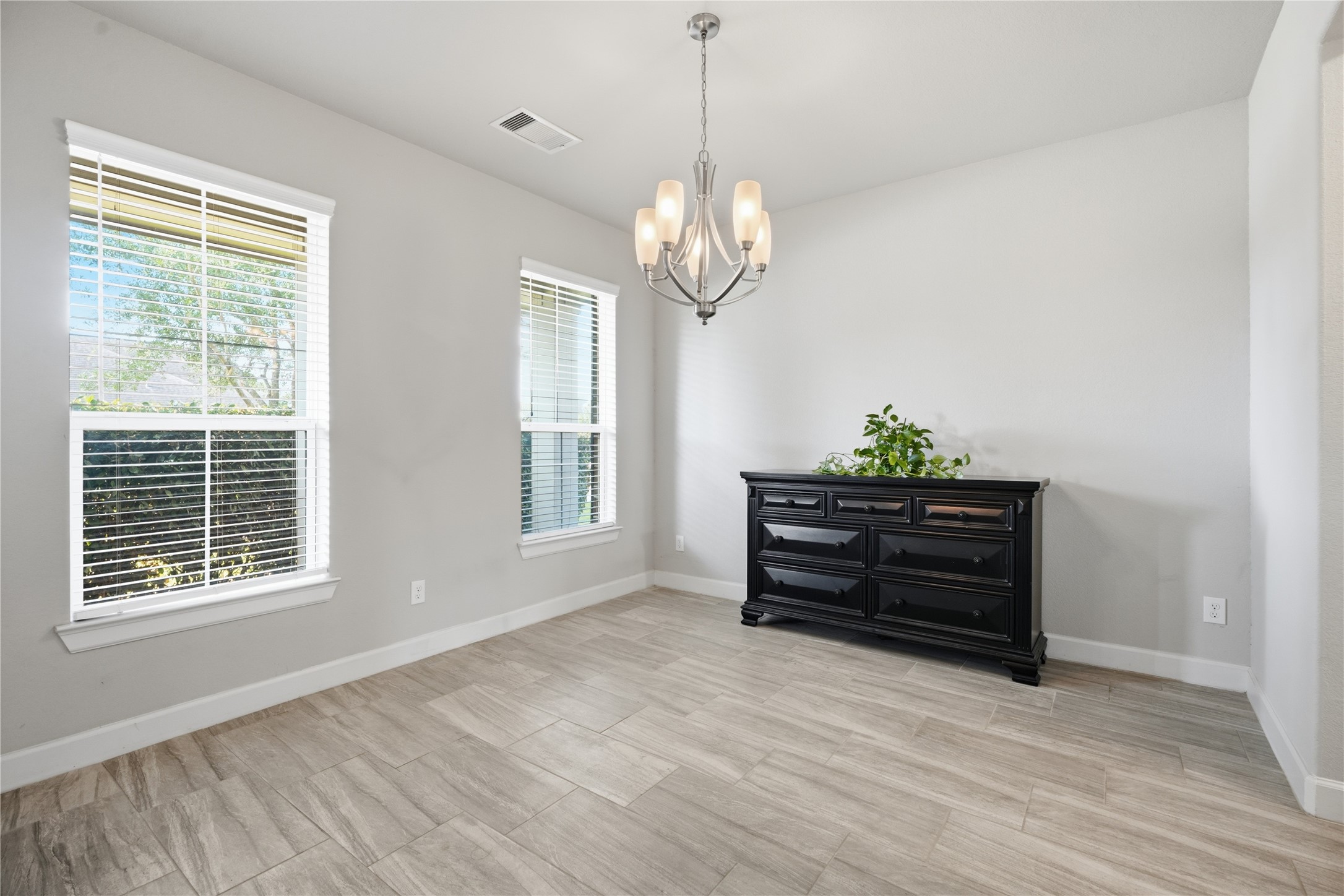 The entry opens to a spacious formal dining area with tile flooring and plenty of room for gatherings.