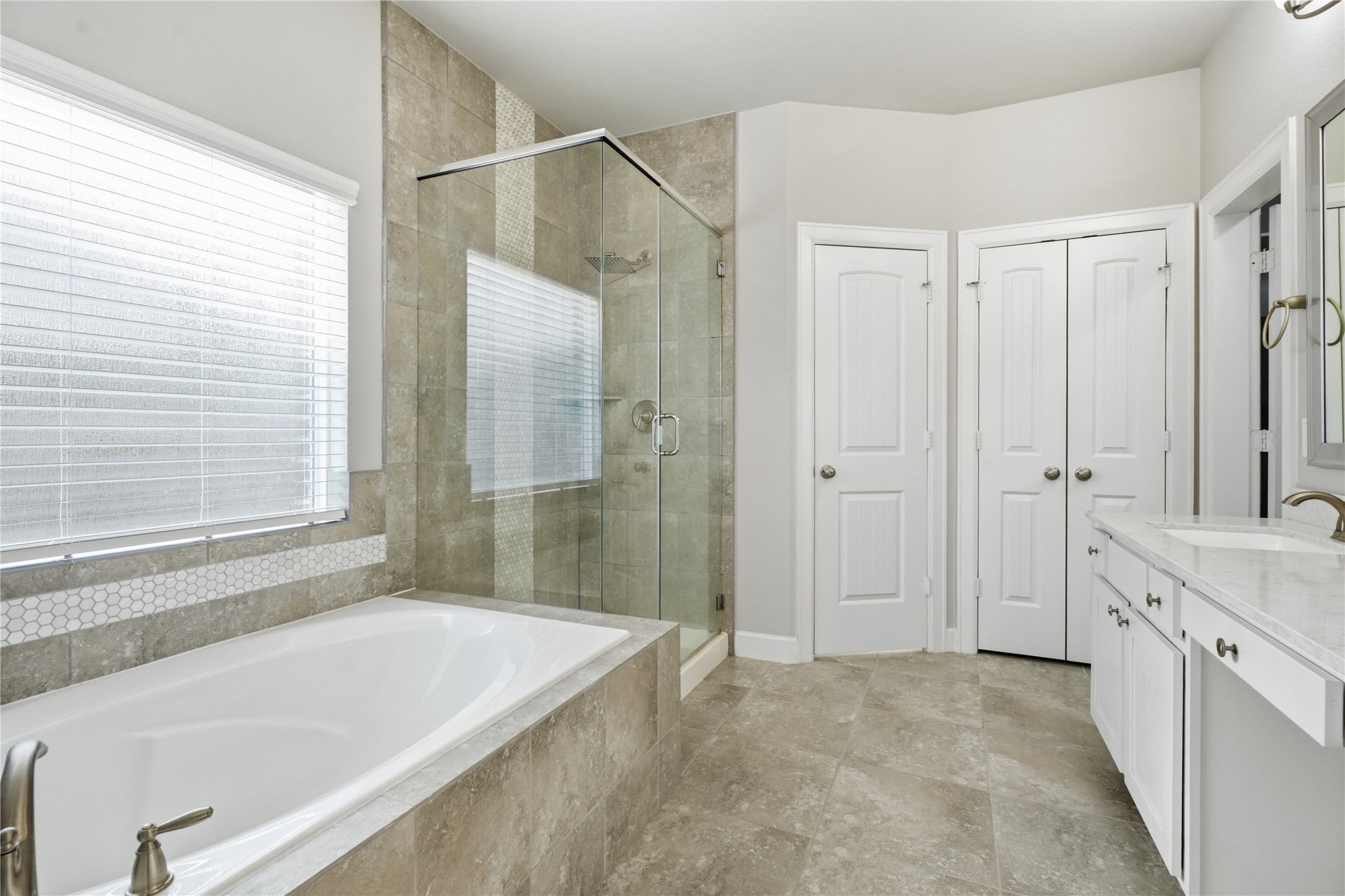 The primary bathroom offers a functional layout with dual sinks, generous cabinetry, updated fixtures, and plenty of room to start and end your day.