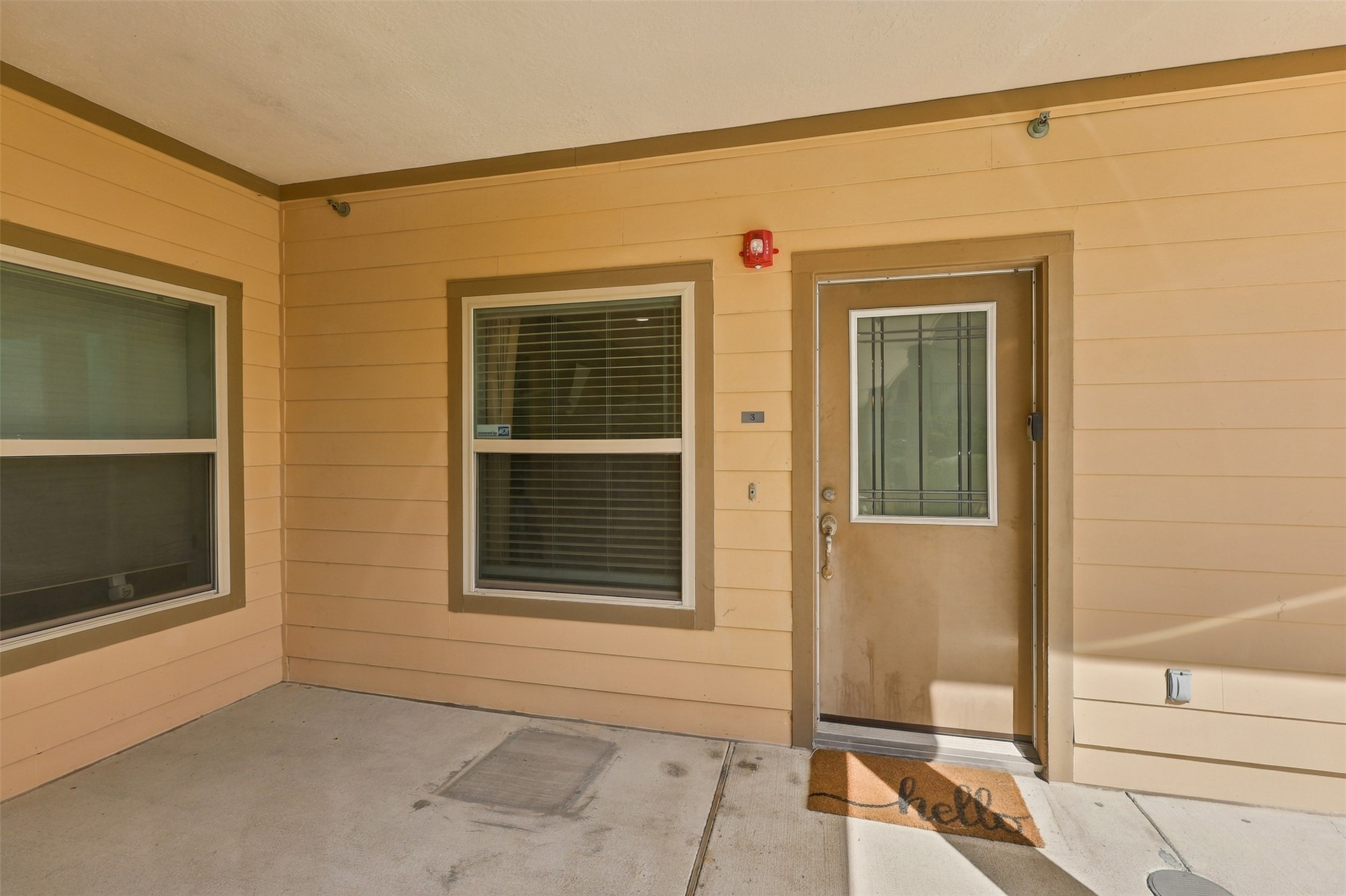Inviting entryway with a warm, neutral exterior, featuring a welcoming doormat and ample natural light through the windows. Inviting entryway with a warm, neutral exterior, featuring a welcoming doormat and ample natural light through the windows.
