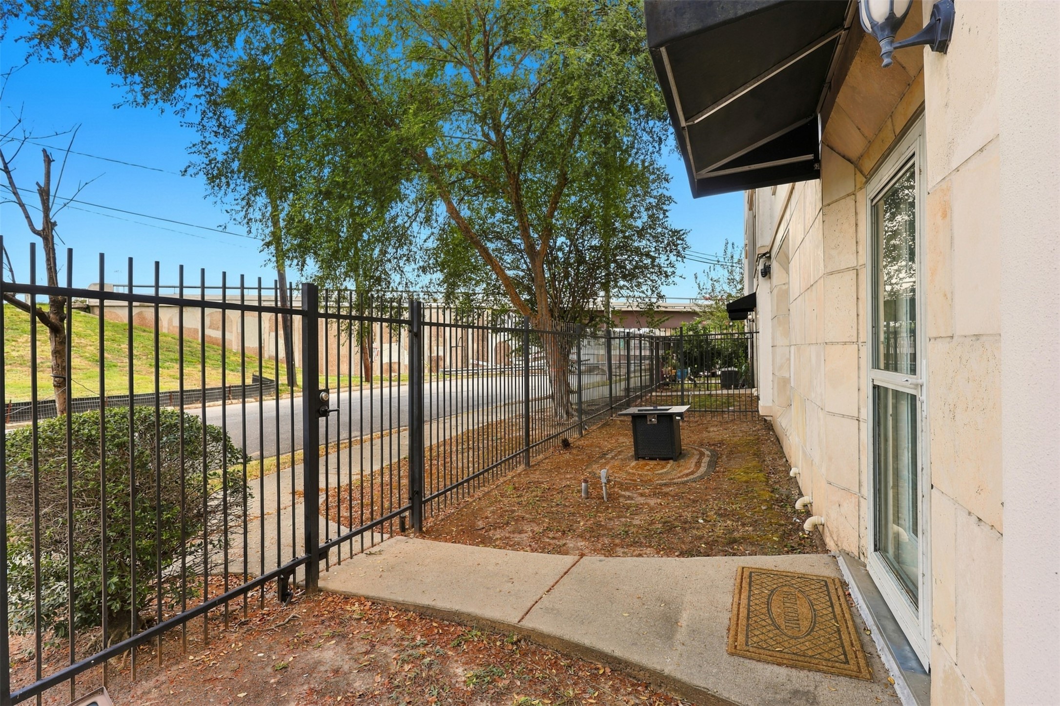 Charming fenced side yard with mature trees, offering privacy and a welcoming entryway. Charming fenced side yard with mature trees, offering privacy and a welcoming entryway.