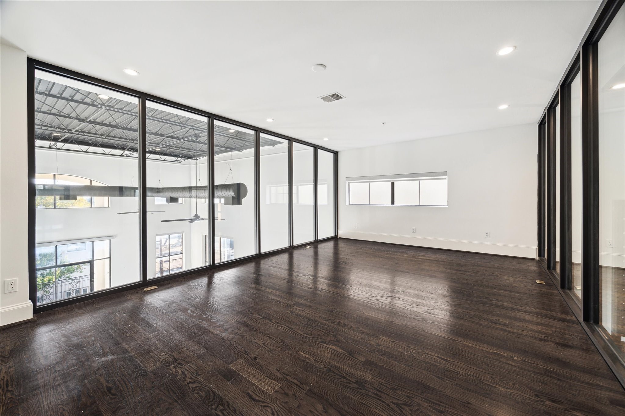Bedroom on the 2nd floor, with big windows overlooking the first floor.