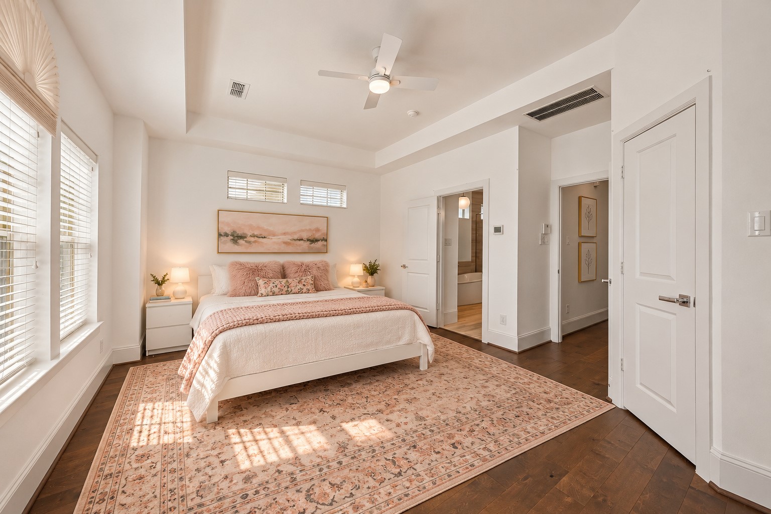 Another perspective of the lovely primary suite highlighting the beautiful tray ceiling, abundant natural light & generous room dimensions. Thoughtfully designed w/ an additional walk-in closet within the bedroom, plus a separate walk-in closet accessible through the primary bath! Wonderful combination of comfort, privacy & storage on the home's 3rd level. Virtually staged.