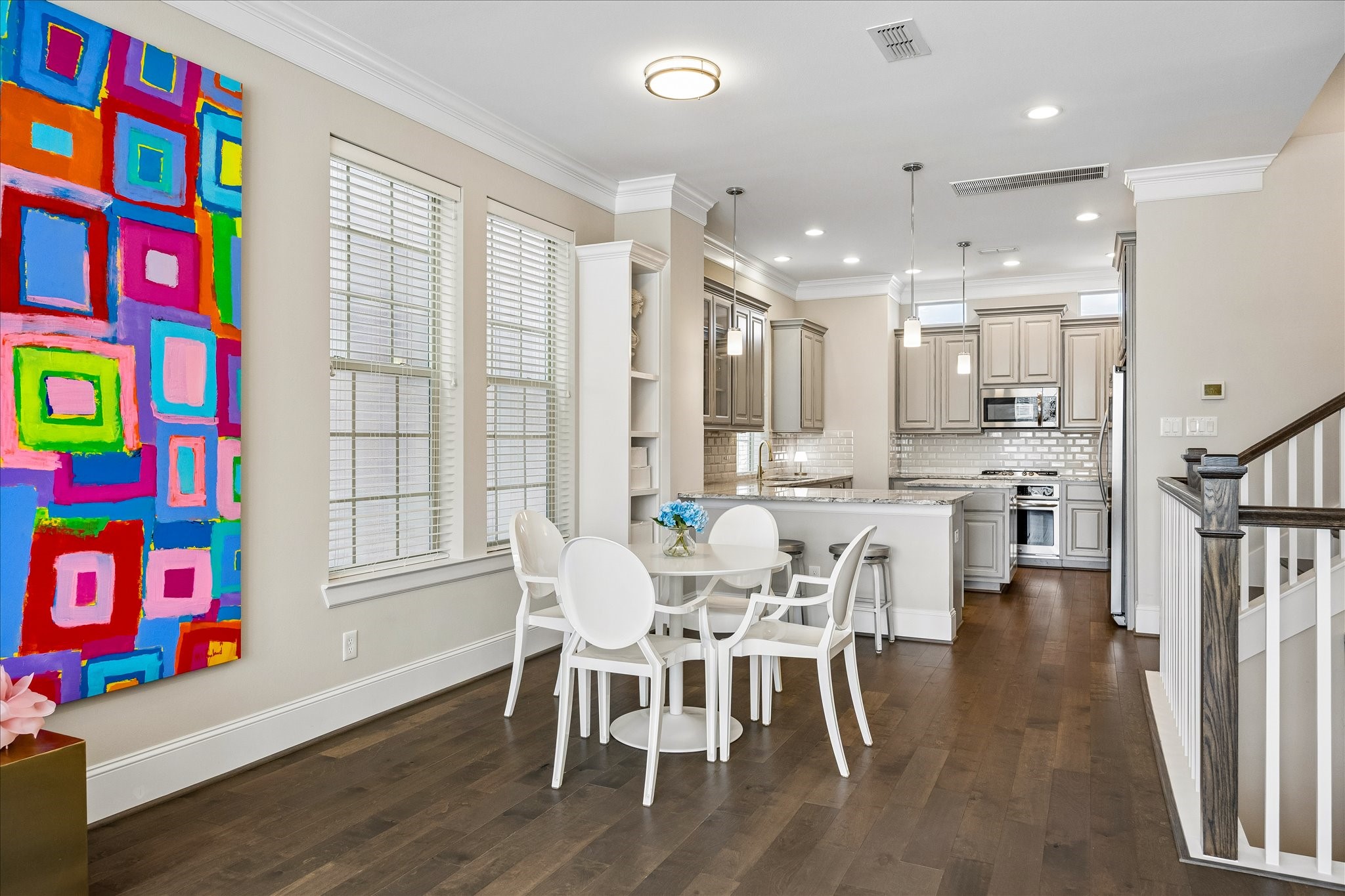 Beautiful light-filled dining area thoughtfully positioned between kitchen & living room on the 2nd floor! Large windows provide wonderful natural light while decorative flush-mount lighting enhances the space. Seamless open-concept layout allows for easy flow between dining & exquisite kitchen; ideal for everyday meals & entertaining!