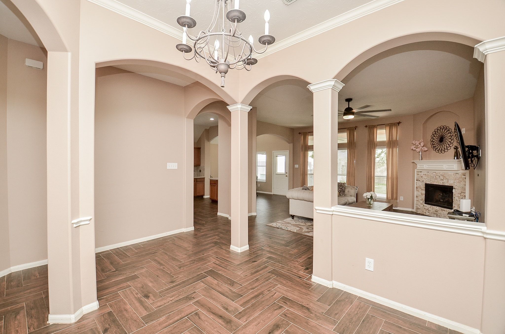 View of the hallway from the formal dining room. Notice the gleaming wood tiles throughout the common areas.