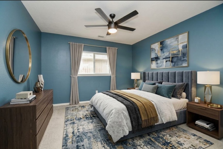 Discover the charm of this virtually staged secondary bedroom, featuring soothing blue walls, modern furnishings, and a cozy atmosphere perfect for relaxation.