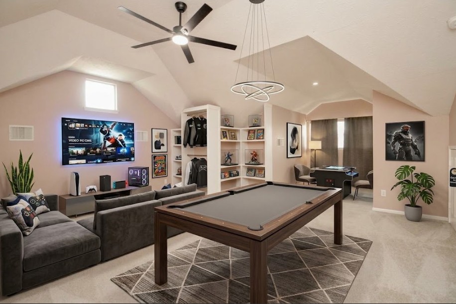 Experience the ultimate in entertainment with this virtually staged game room, featuring a sleek pool table, cozy lounge area with a large screen TV, and stylish modern decor, perfect for relaxation and fun.