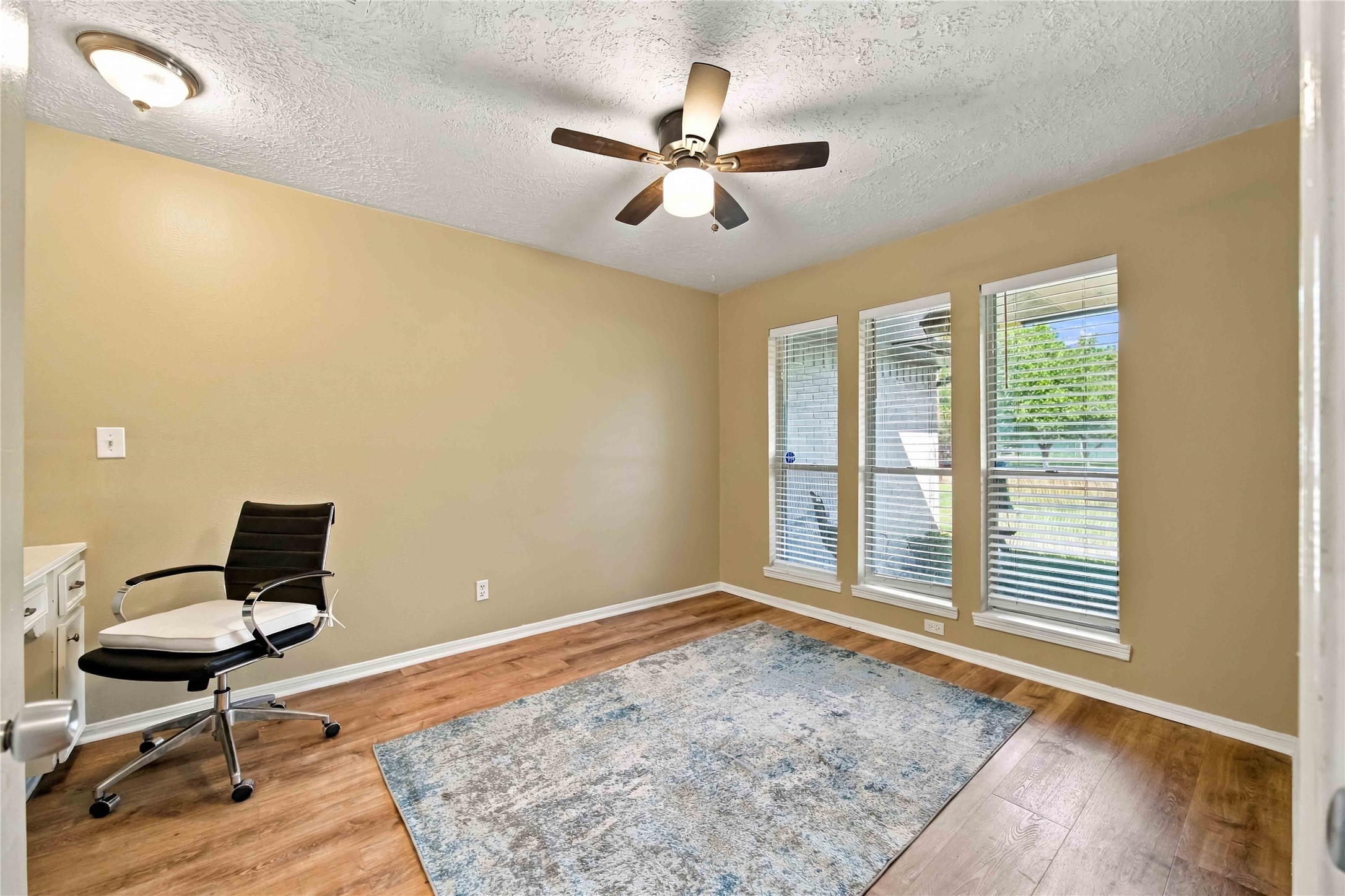 This secondary bedroom has a grearview of the property