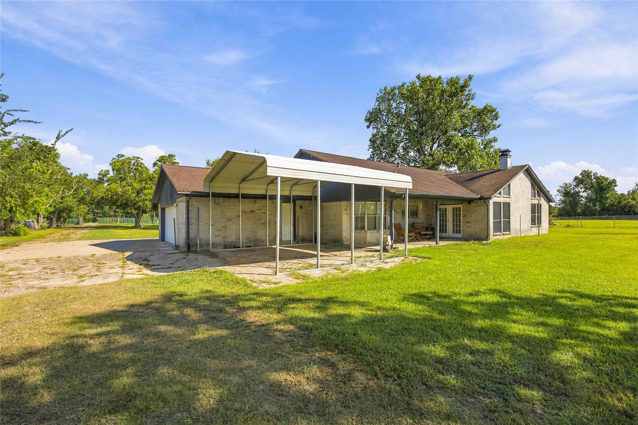 Sitting on the back Patio in the rolling chairs enjoying your view of the Elm, Cypress and Maoplke trees.