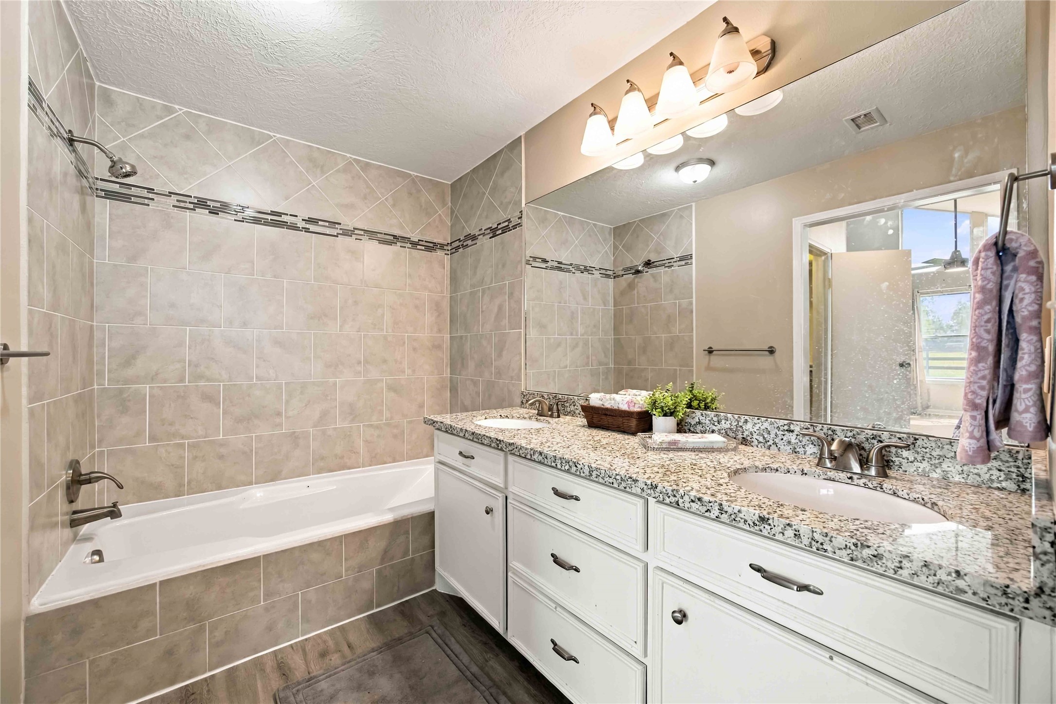 Double vanity, granite and tub/shower.