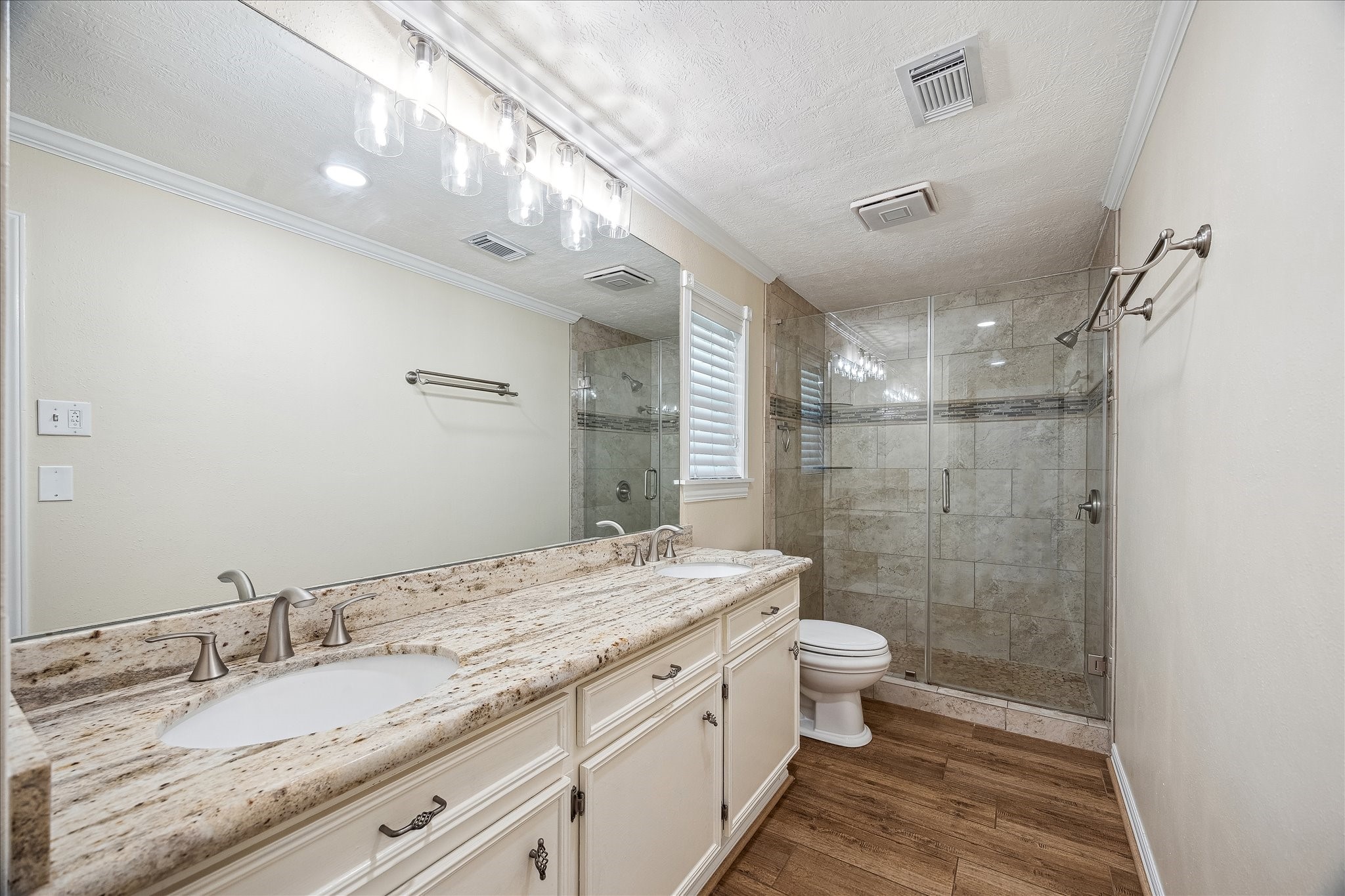 Primary bath features double vanities and walk-in shower