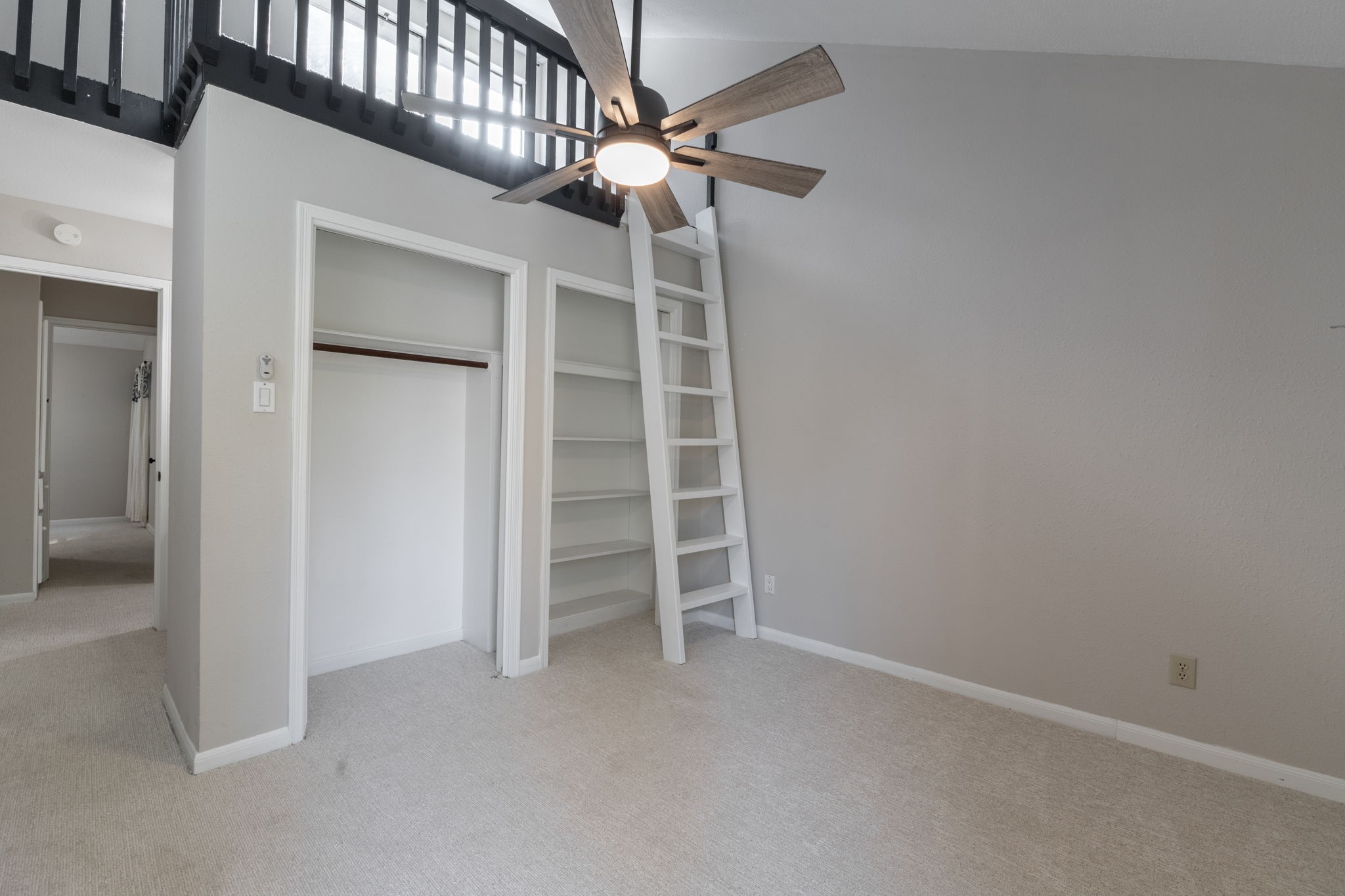 secondary room with fun loft area and two closets