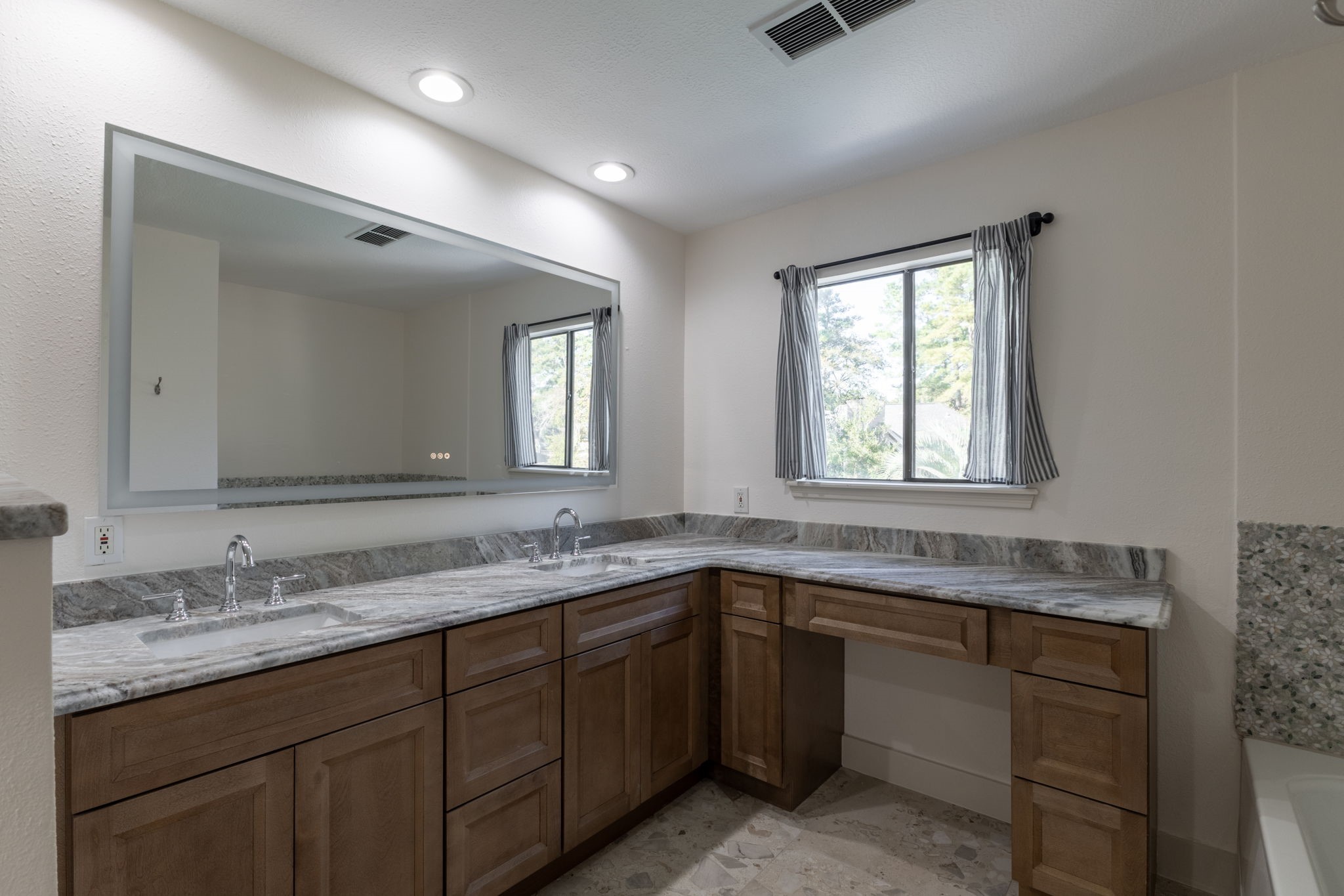 68in LED fog proof mirror. Vanity out looking the tree tops