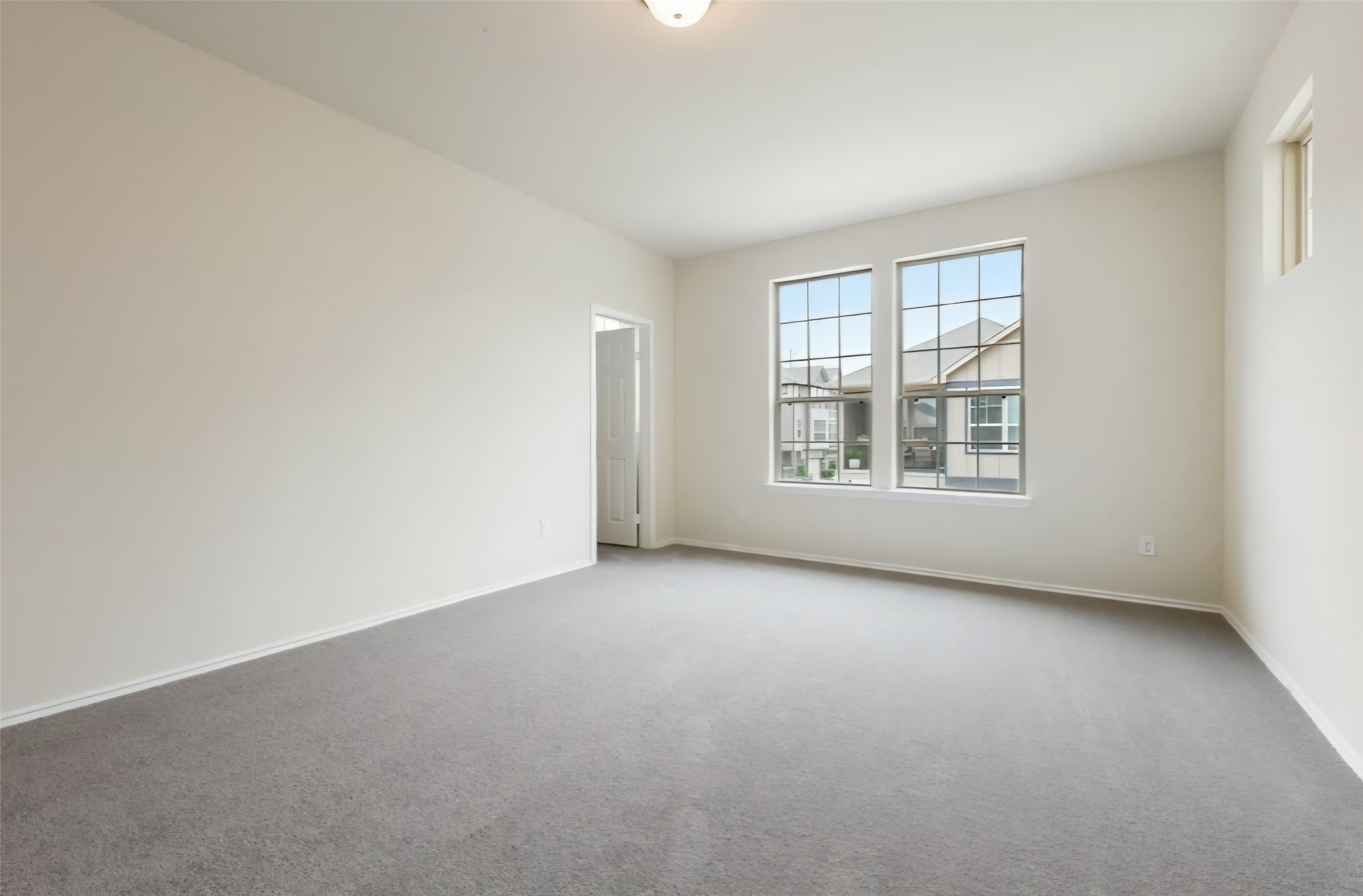 Spacious primary bedroom with good amounts of windows including architectural accent windows for great enhanced natural lighting