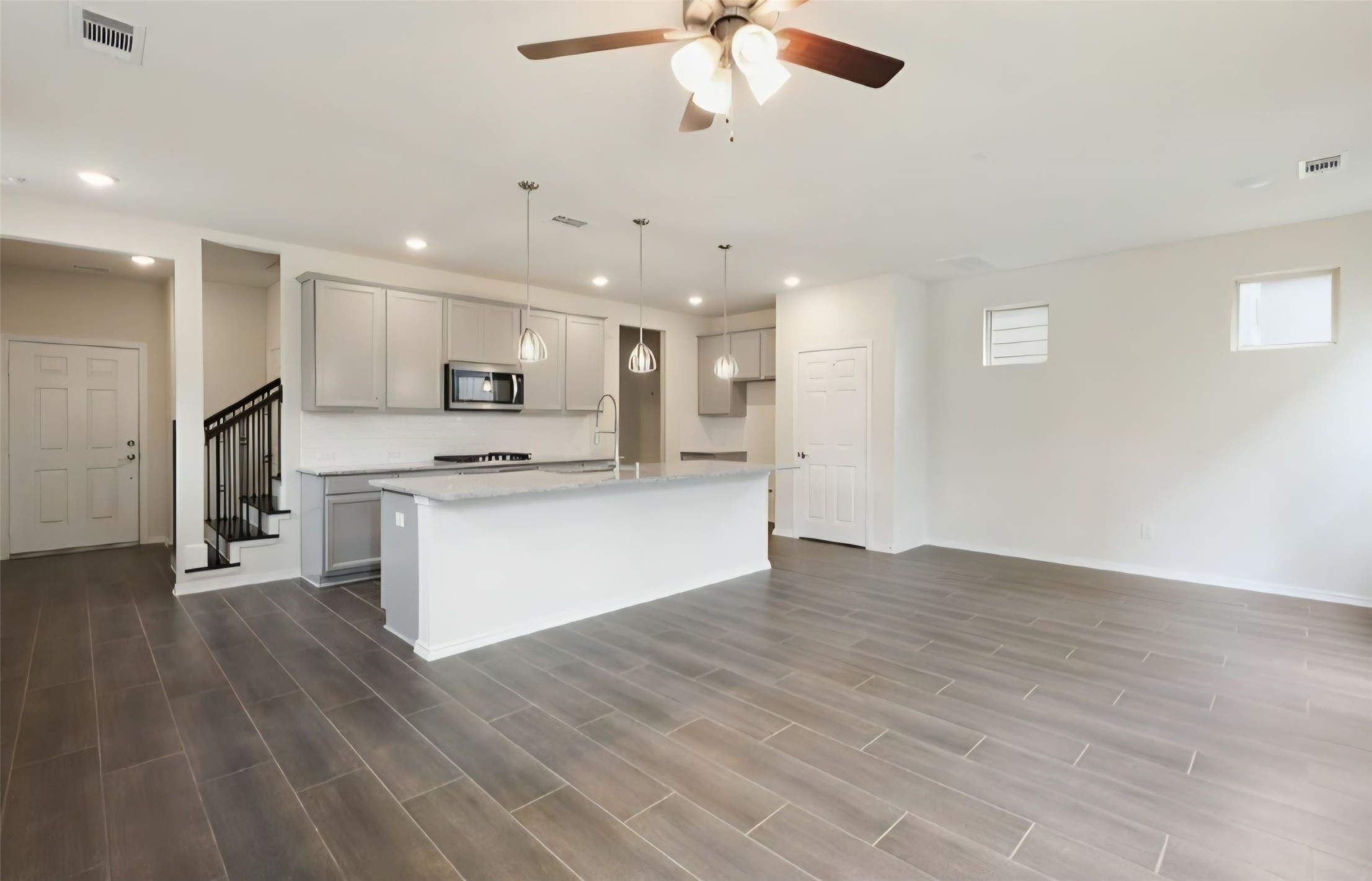 Spacious family room area with architectural accent windows that enhance natural lighting