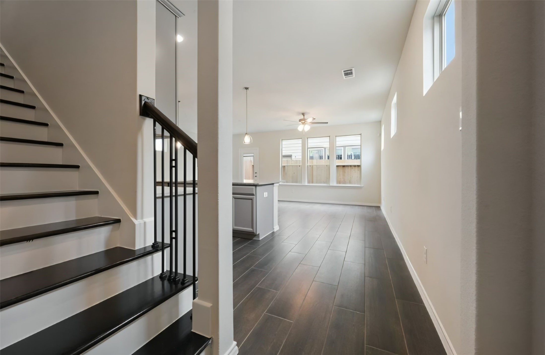 Nice entry, greets with elevated ceilings, elegant staircase with solid wood treads, white painted risers and a minimalist accent of modern wrought-iron balusters providing character to this home