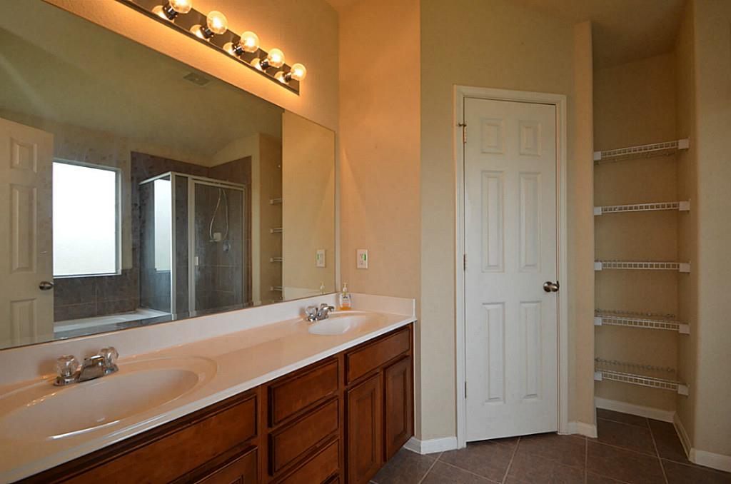 Elegant primary bath with dual sinks and a spacious mirror.