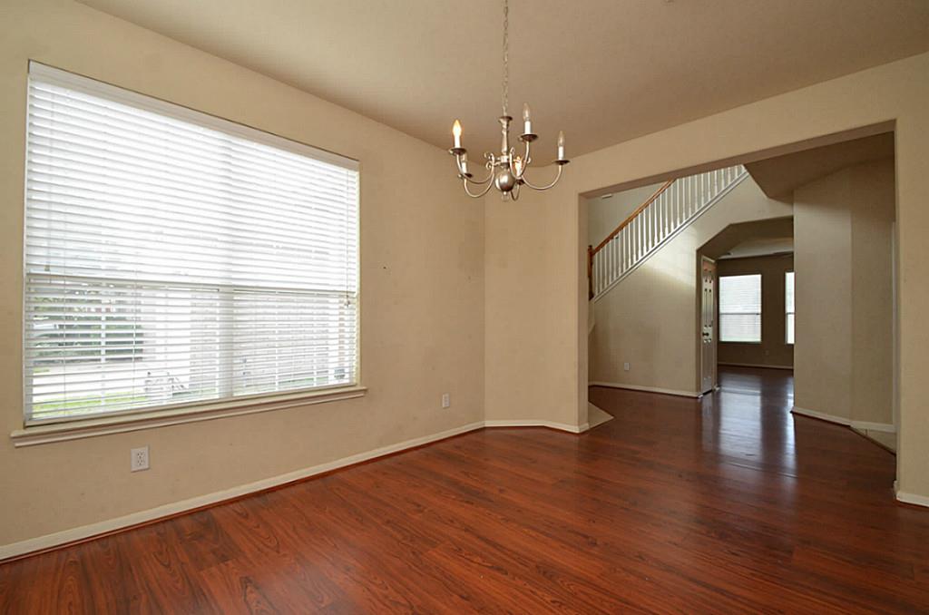 Bright dining area featuring elegant light fixtures, creating a welcoming ambiance.