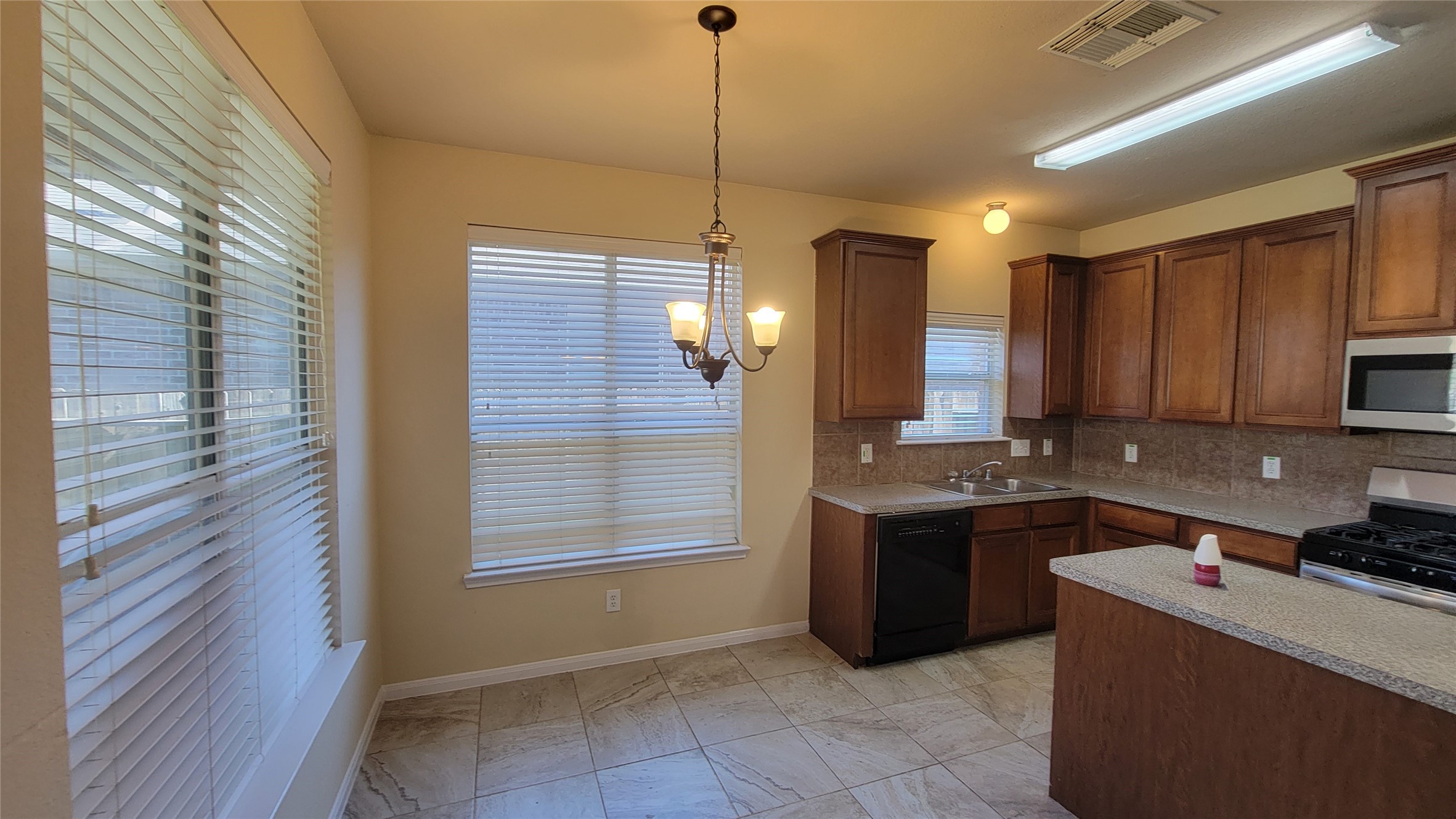 This kitchen features elegant wood-finished cabinetry, adding warmth and style.