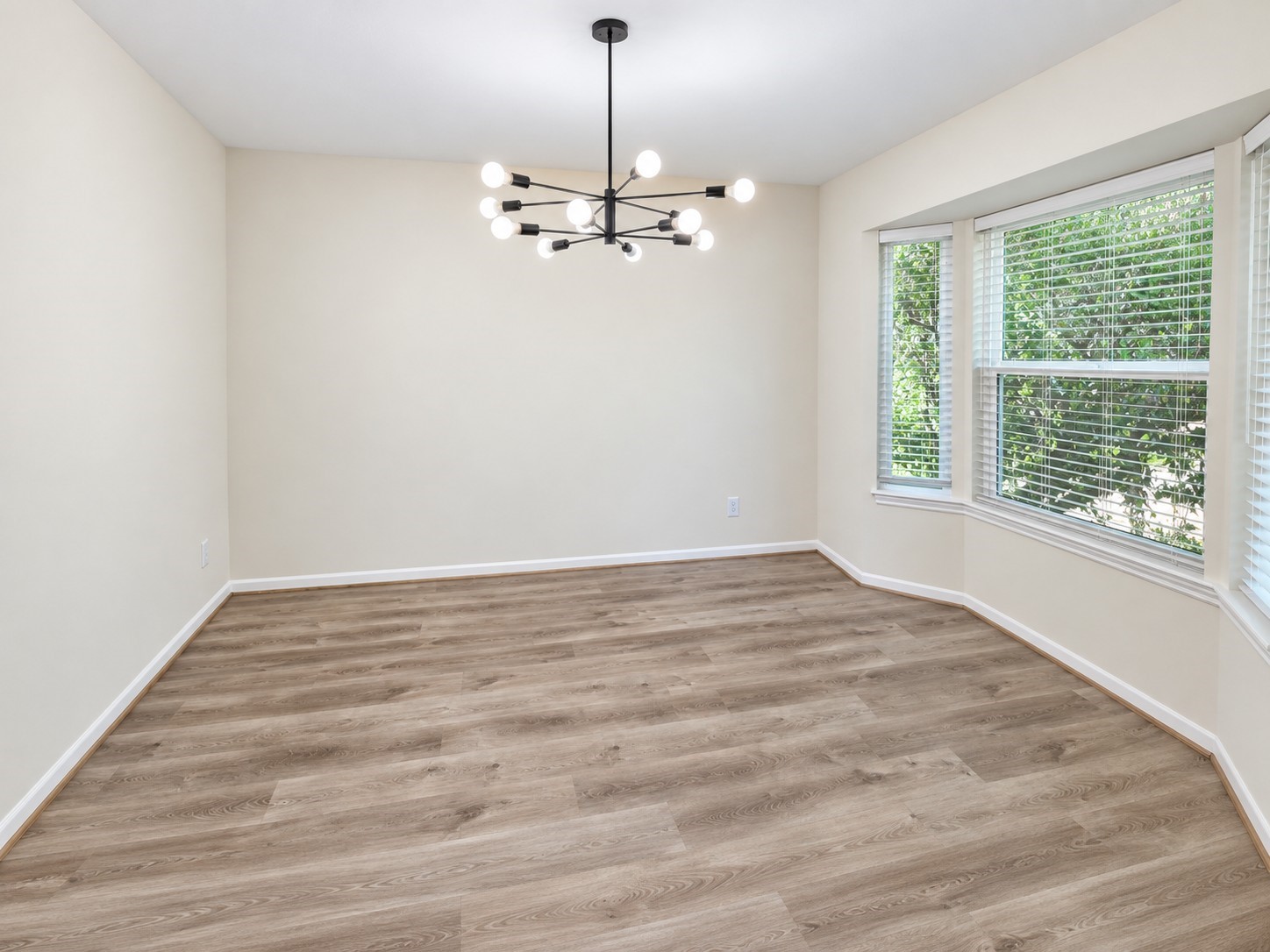 Light-filled dining room with bay windows creates an inviting setting for meals and gatherings.