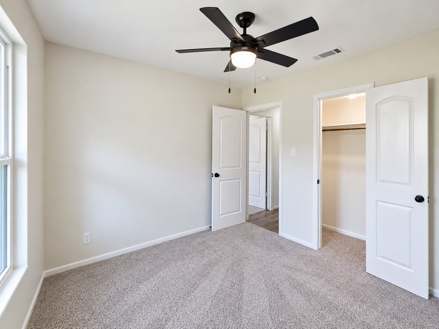 Additional secondary bedroom provides flexible space for family, guests, or a second home office.