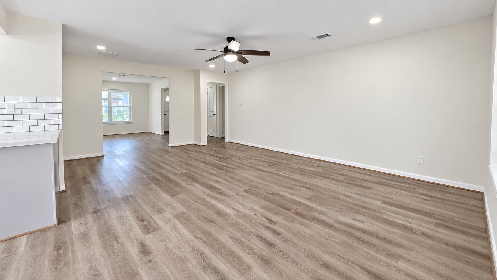 Wide-angle view showcases the size of the main living room and its versatile furniture possibilities.