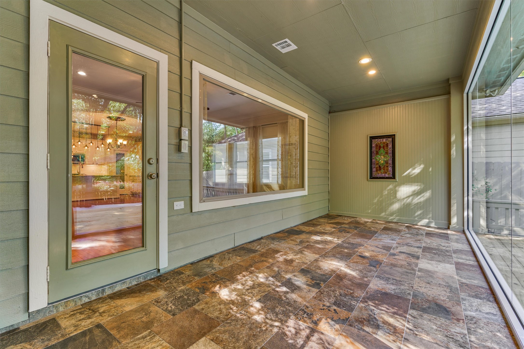 Off of the living room and primary bedroom is a beautiful sunroom!
