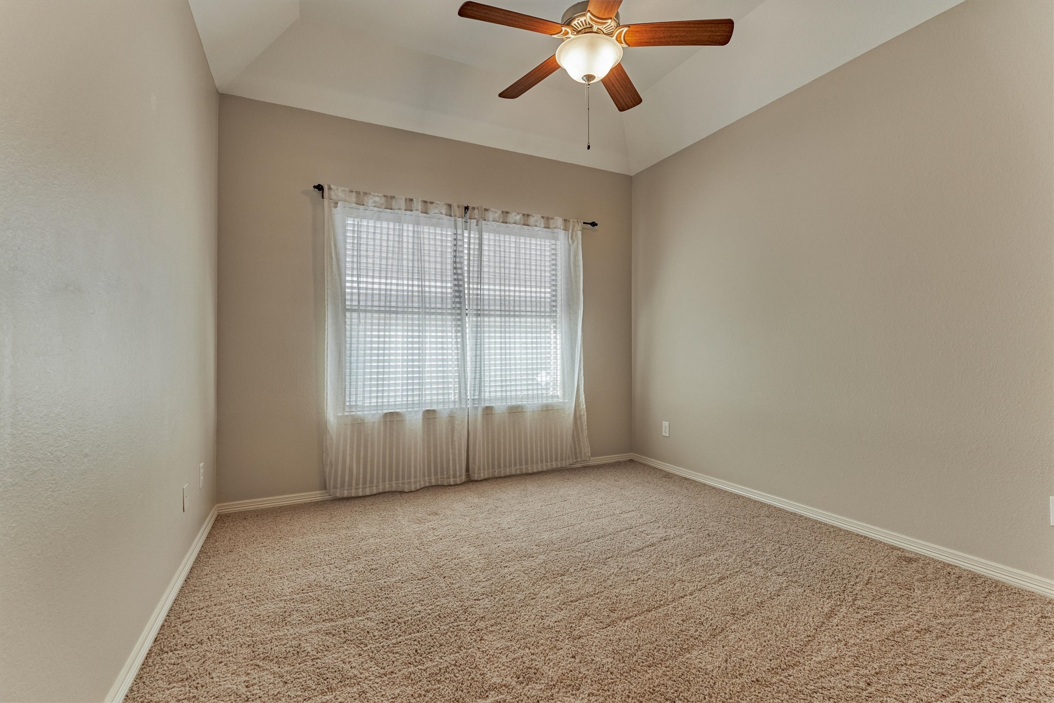 A third bedroom is bright with natural light.