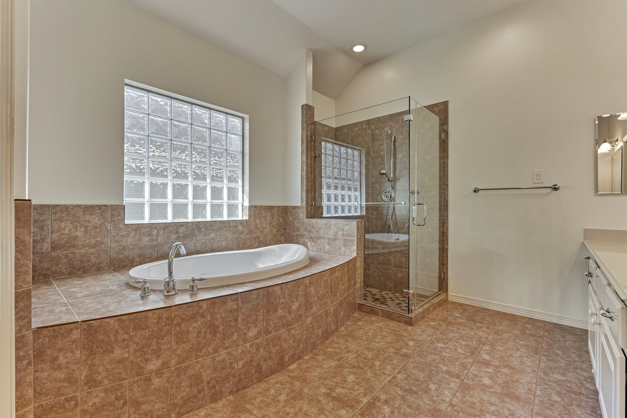 Large soaking tub and separate shower in the primary bath.