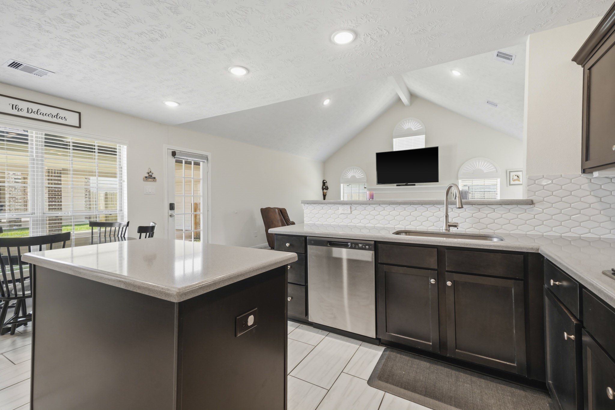 Kitchen, featuring side door access and island.