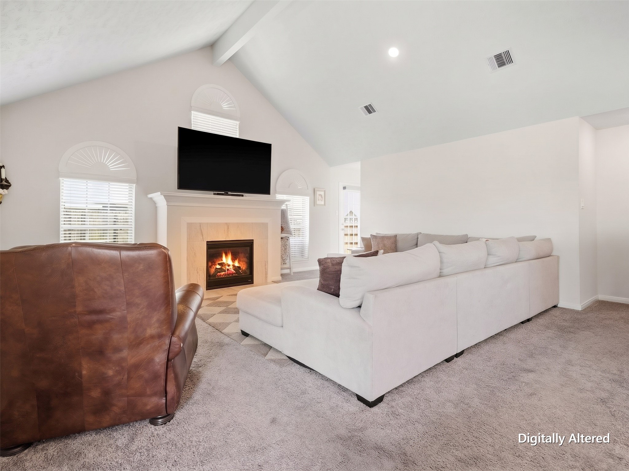 Living area with vaulted ceilings, custom blinds and illuminated fireplace. Digitally enhanced for visual clarity; decor and visual clutter removed only.