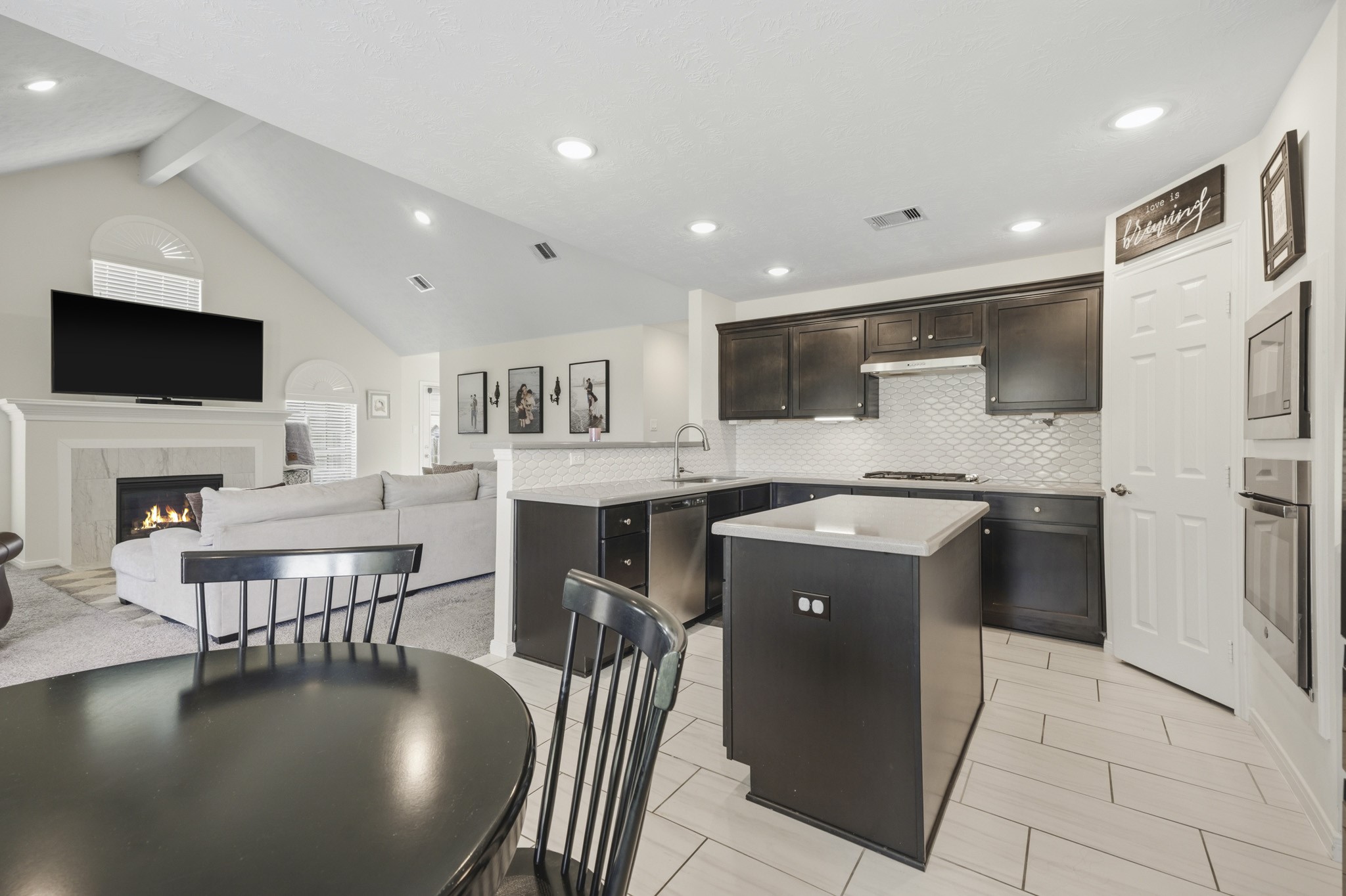 Open concept kitchen with island and walk-in pantry.