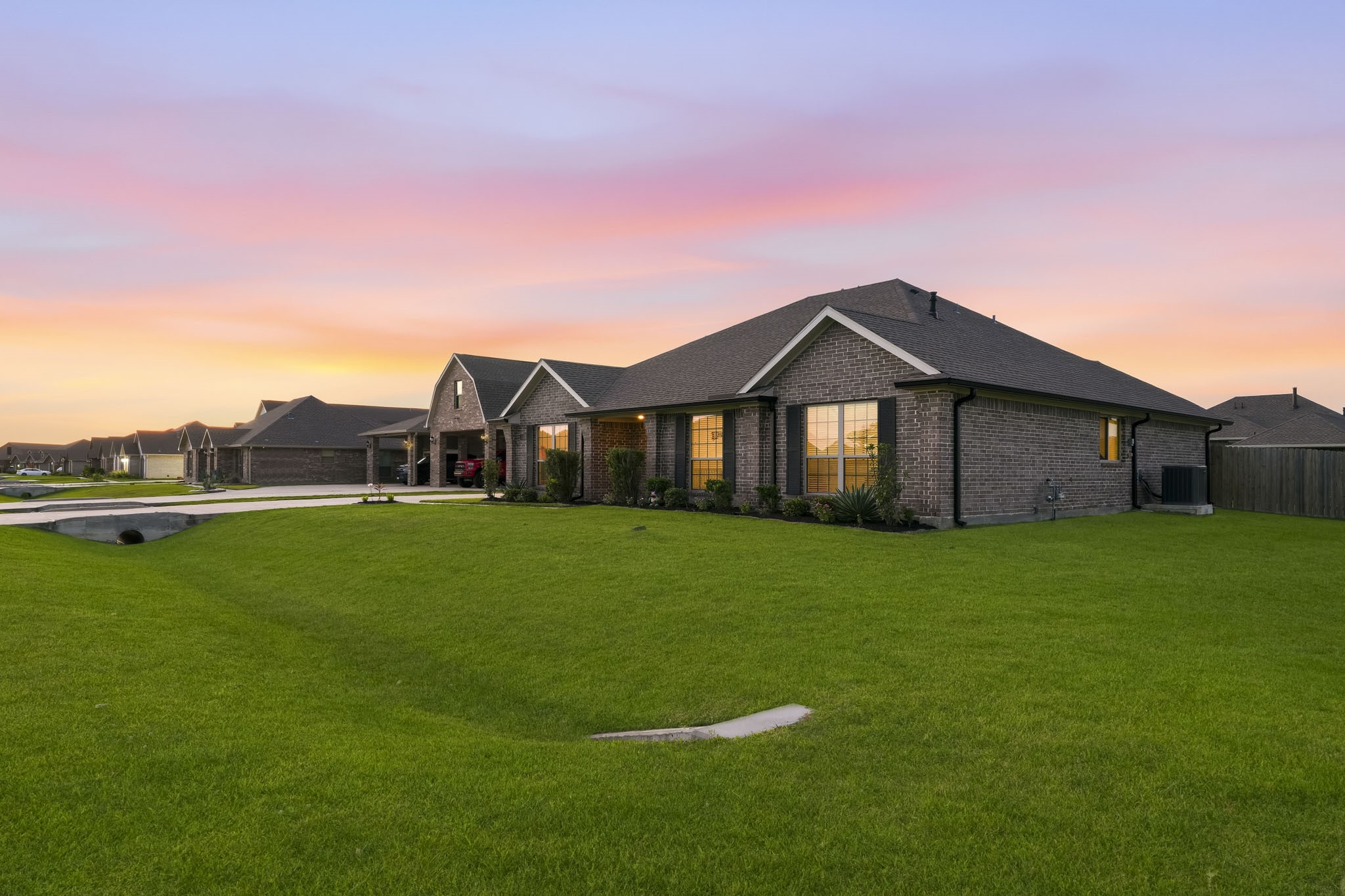Side view of home featuring lush grass.