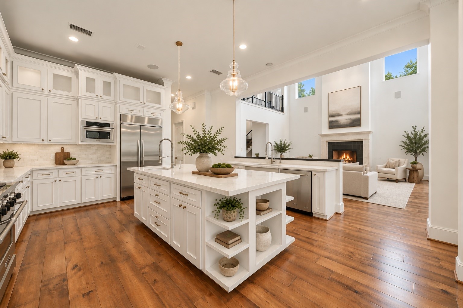 The kitchen opens beautifully to the grand living area, creating a seamless flow that makes entertaining feel effortless! Custom white cabinetry, expansive quartz countertops, and a generous island with built in storage complement the warm wood flooring, while the soaring ceilings and open sightlines bring an airy, welcoming feel to the heart of the home. *Virtually Staged