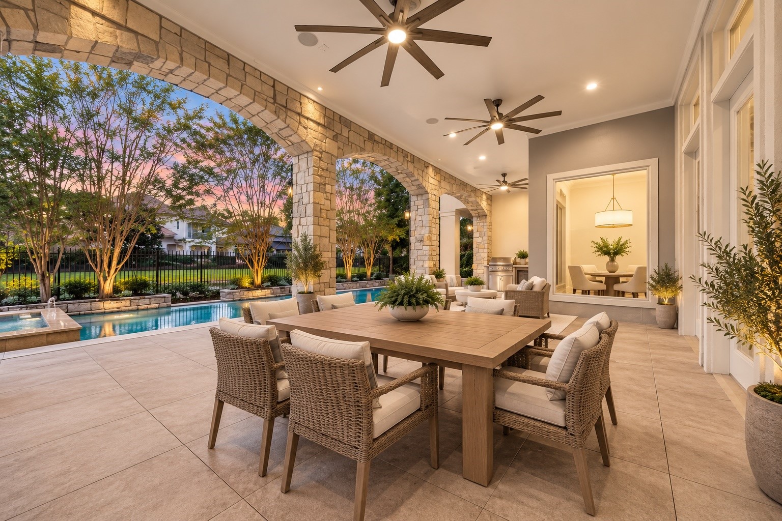 Extend your living space outdoors to this expansive covered patio, where elegant stone arches, soaring ceilings, and generous seating areas create the perfect setting for entertaining! With a built in outdoor kitchen, refreshing pool views, and plenty of room to gather, every evening here feels like a luxury getaway in the comfort of home. *Virtually Staged