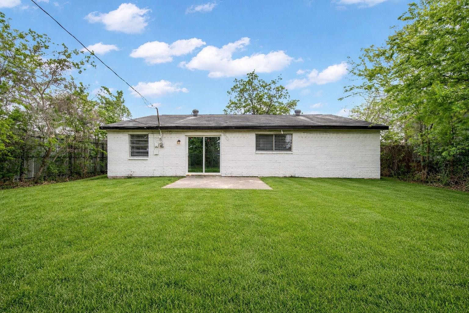 The concrete back patio provides an inviting outdoor setting, ideal for alfresco dining, weekend grilling or enjoying a peaceful morning surrounded by the comforts of your own backyard.