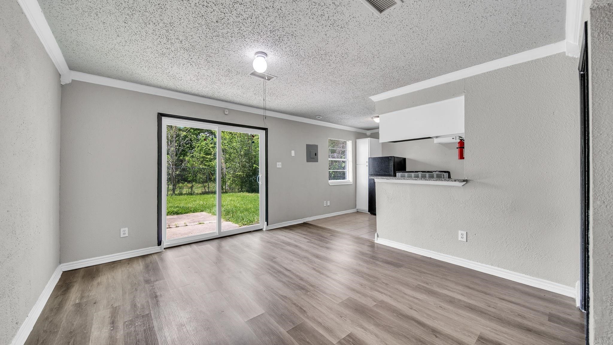 A sliding glass door invites natural light into the living space while providing seamless access to the backyard. With no rear neighbors, the outdoor setting offers an exceptional sense of privacy and a peaceful backdrop for relaxing and enjoying the outdoors.