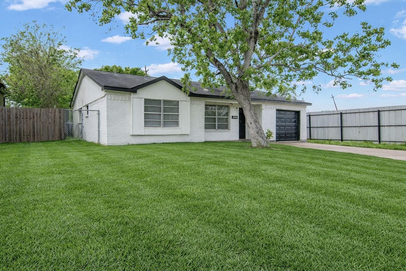 The single-car garage offers convenient, secure parking and features a newly installed automatic garage door opener. Utility hookups provide added functionality, including a dedicated electric dryer connection.